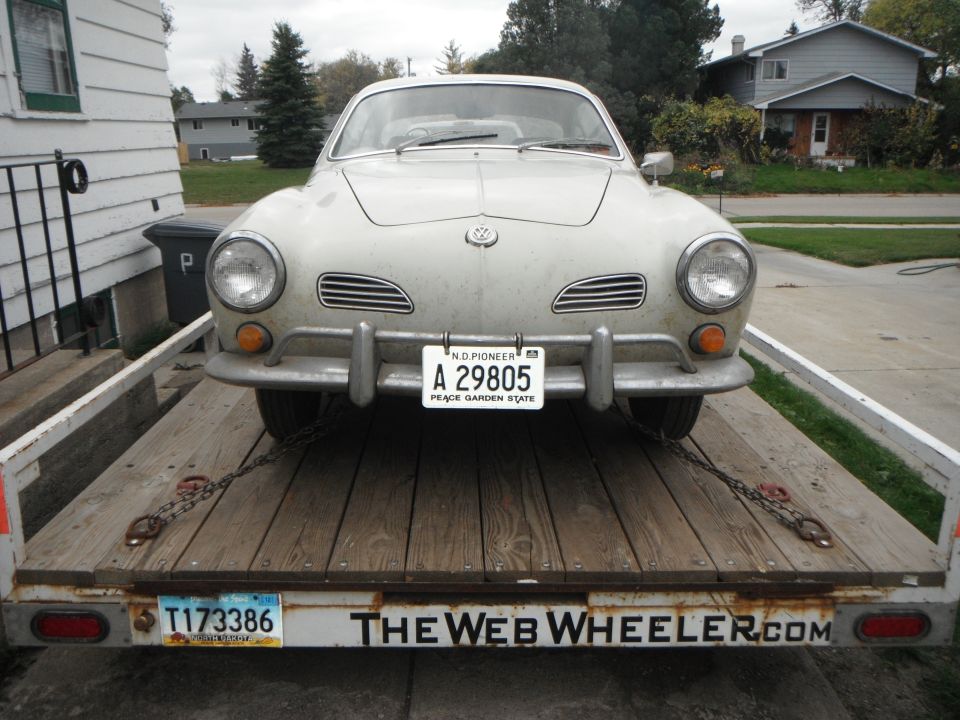 Front view of a 1969 Volkswagen Karmann Ghia on a flatbed trailer