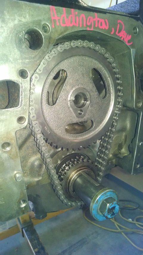 1979 Ford Bronco - Close-up of engine timing chain and gears with handwritten text on the block.