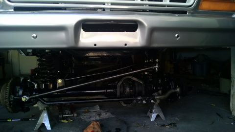 1979 Ford Bronco - Undercarriage view of a 1979 Ford Bronco, showing its front suspension and drivetrain components.