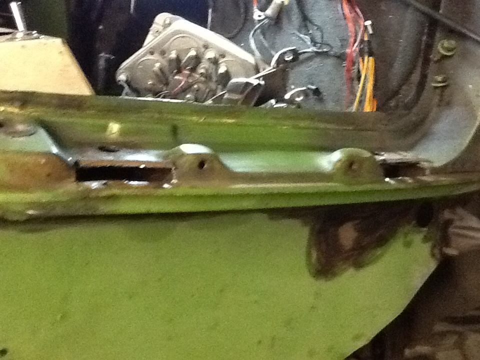Green 1988 Suzuki Samurai interior showing rusted door frame and exposed wiring