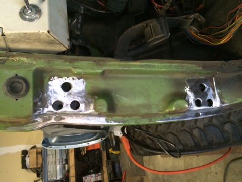 1988 Suzuki Samurai - This photo shows a section of a vehicle's frame undergoing repair, with welded metal plates and exposed wiring.