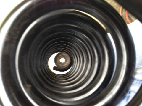 1996 Ford Bronco - A coil spring is shown from the inside, looking towards the center.