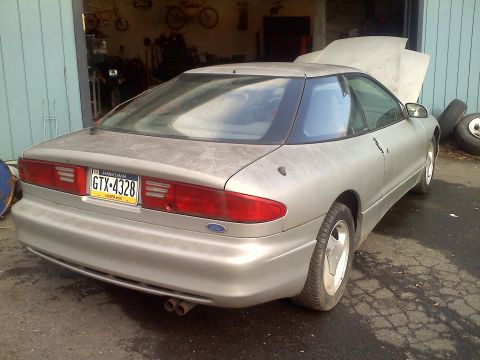 1993 Ford Probe - This 1993 Ford Probe GT is seen from the rear with its hood open, parked in a garage.