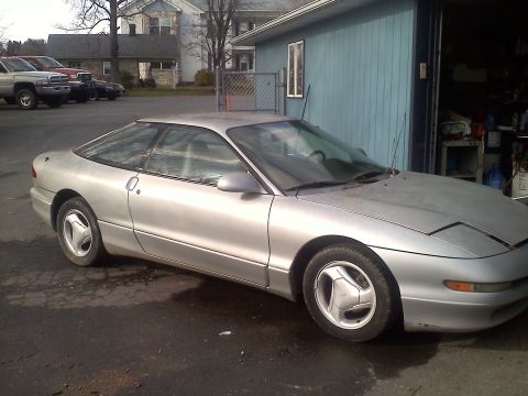 1993 Ford Probe - A silver 1993 Ford Probe GT is seen parked in front of a garage.