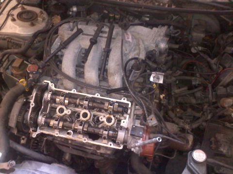 1993 Ford Probe - Close-up view of an engine bay with the valve cover removed, revealing internal components.