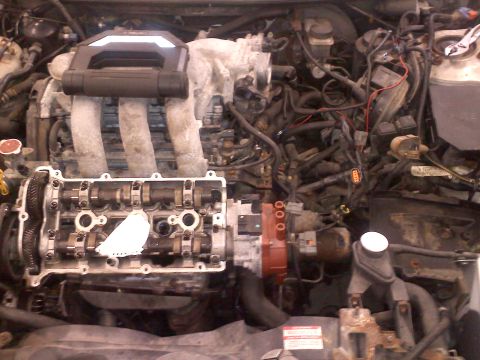 1993 Ford Probe - Engine bay with valve cover removed, exposing camshafts and intake manifold components.