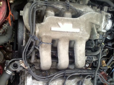 1993 Ford Probe - This is a close-up view of an engine's intake manifold, showing various hoses and wiring.