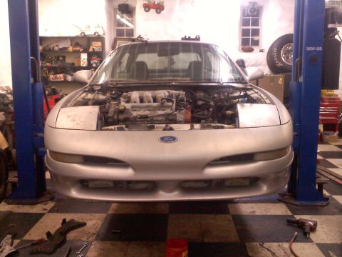 1993 Ford Probe - Silver 1993 Ford Probe on a lift with its hood open, revealing the engine bay.