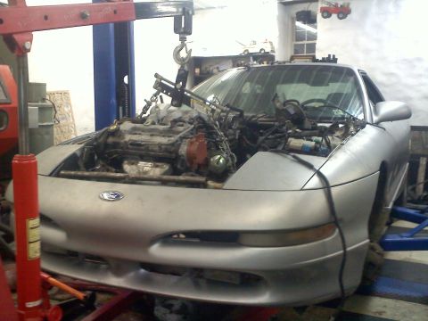 1993 Ford Probe - Silver 1993 Ford Probe GT in a workshop, engine removed and suspended by a hoist.