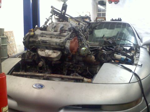 1993 Ford Probe - Engine removal in progress on a silver 1993 Ford Probe GT.