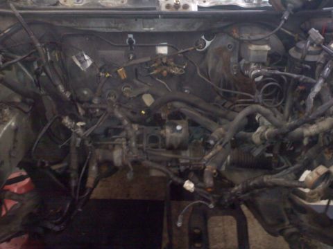 1993 Ford Probe - The engine bay is shown with a complex network of wiring and hoses, partially disassembled. A Supermotors.net watermark is visible.