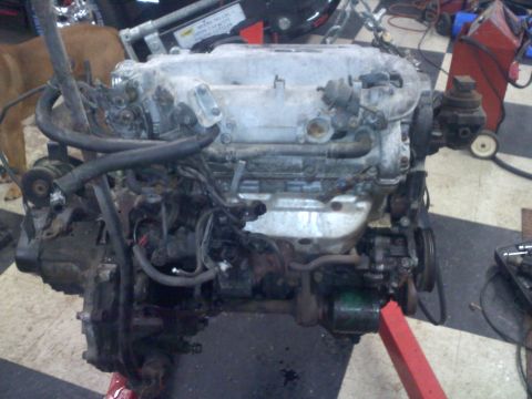 1993 Ford Probe - Engine assembly on a stand, showing various hoses and components.