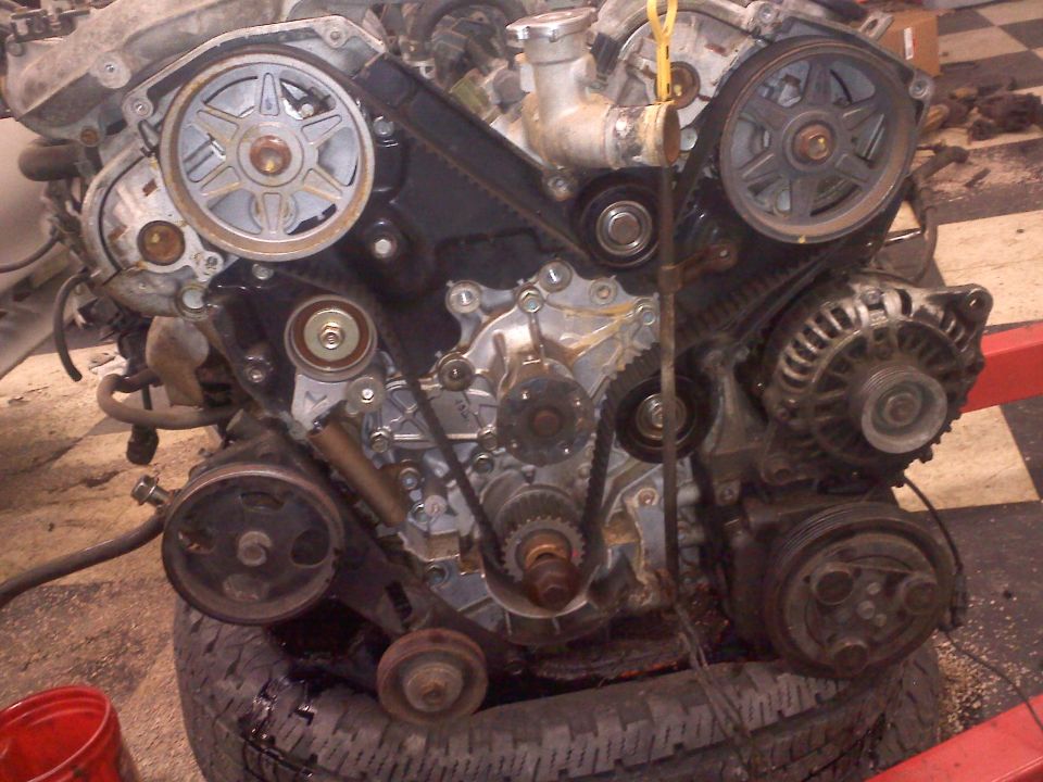 Engine assembly with belts and pulleys visible