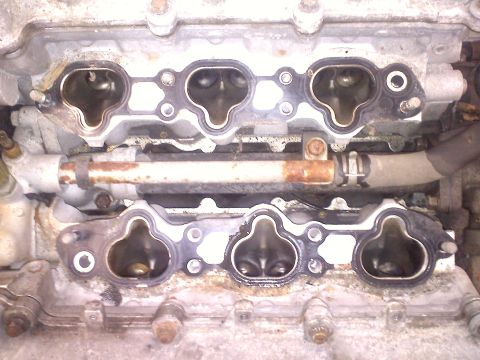 1993 Ford Probe - Close-up view of engine intake manifold ports and gasket sealing surface.
