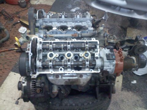 1993 Ford Probe - Engine assembly with visible camshafts, valves, and timing gears, likely undergoing maintenance or repair.