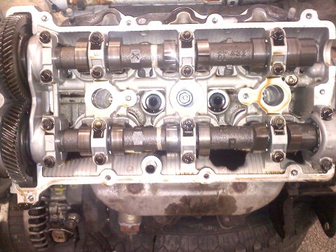 1993 Ford Probe - The internal components of a car engine are visible after the valve cover has been removed.