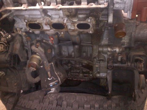 1993 Ford Probe - Engine block and intake manifold assembly, showing signs of wear and oil residue.