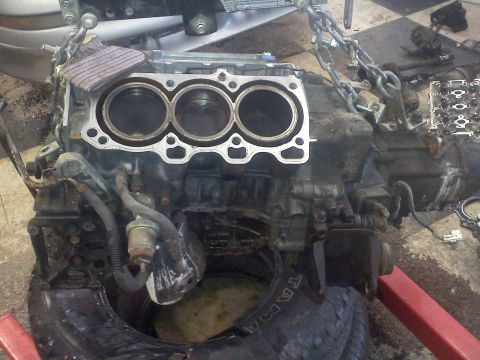 1993 Ford Probe - Engine block with pistons exposed, undergoing repair or disassembly.