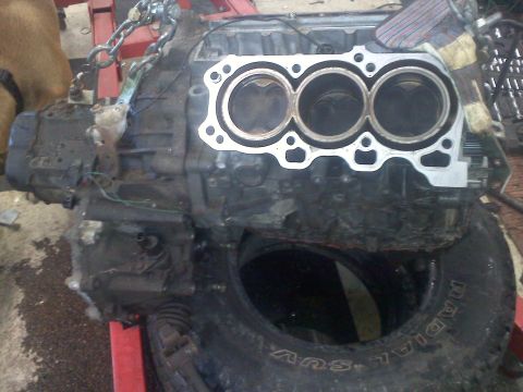 1993 Ford Probe - Engine block with visible pistons, likely removed from a vehicle for repair or replacement.