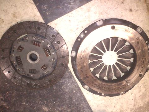 1993 Ford Probe - Clutch disc and pressure plate components are shown on a checkered floor, with a watermark for Supermotors.net.