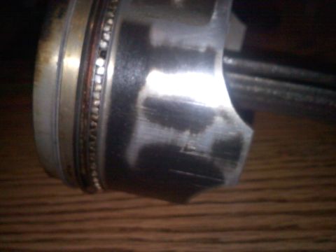 1993 Ford Probe - This image shows a close-up of a damaged piston, not a 1993 Ford Probe.