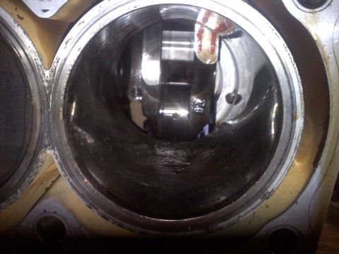 1993 Ford Probe - View inside an engine cylinder, revealing internal components like the crankshaft and connecting rod.
