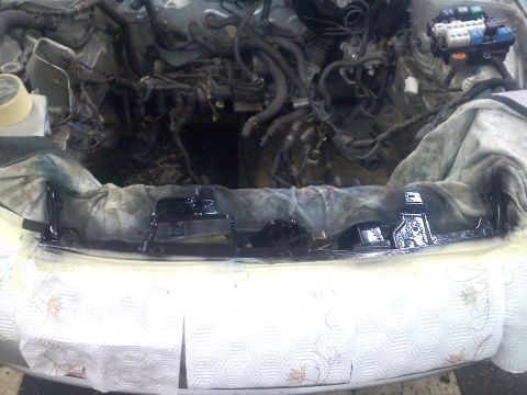 1993 Ford Probe - The engine bay of a vehicle is shown with various parts and wiring exposed, suggesting maintenance or repair work.