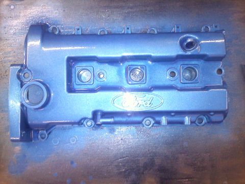 1993 Ford Probe - A blue Ford valve cover is shown, the embossed Ford logo in the center.