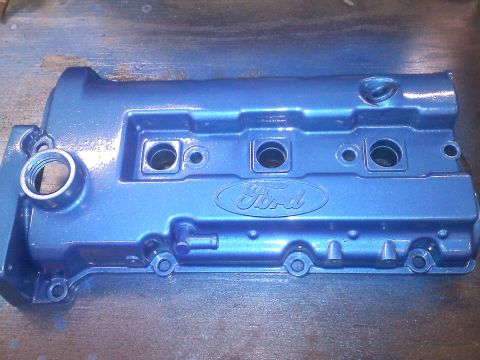 1993 Ford Probe - A blue metallic Ford valve cover is shown, with the Ford logo embossed on its surface.