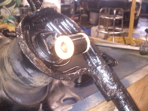 1993 Ford Probe - Close-up of a vehicle suspension component a white bushing.