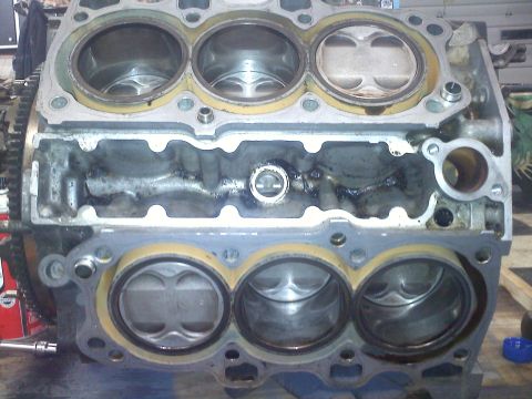 1993 Ford Probe - Close-up view of a disassembled engine block, revealing pistons and cylinder bores.
