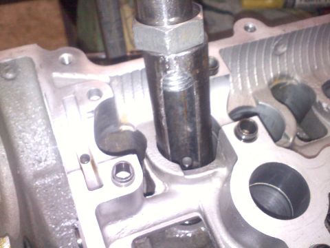 1993 Ford Probe - Close-up view of an engine's cylinder head, showing internal components and a tool.