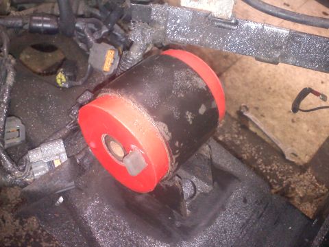 1993 Ford Probe - Close-up view of a red engine component with a black hose attached.