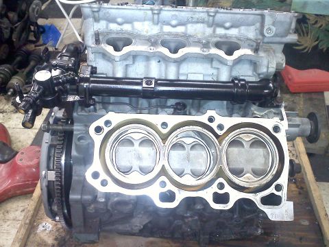1993 Ford Probe - Close-up of an engine block showing pistons and internal components, with a "SuperMotors.net" watermark.