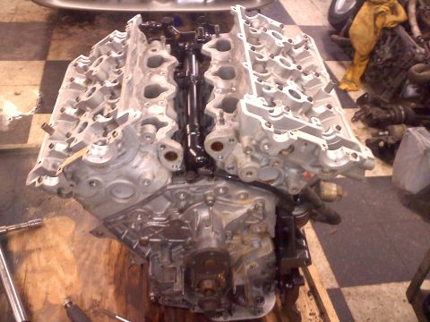 1993 Ford Probe - Engine block assembly resting on a wooden surface, showing internal components.