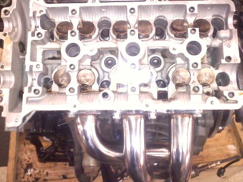 1993 Ford Probe - This is a close-up view of an engine's cylinder head and exhaust manifold, showing internal components.