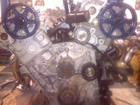 1993 Ford Probe - Close-up view of an engine's internal components, focusing on the timing belt system.