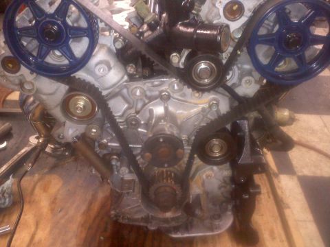 1993 Ford Probe - Close-up view of an engine's internal components, including pulleys and belts.