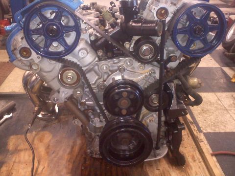1993 Ford Probe - Close-up view of an engine assembly, prominent blue-painted pulleys and a visible timing belt system.