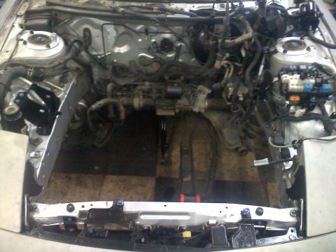 1993 Ford Probe - The engine bay of a vehicle, showing exposed wiring and mechanical components.