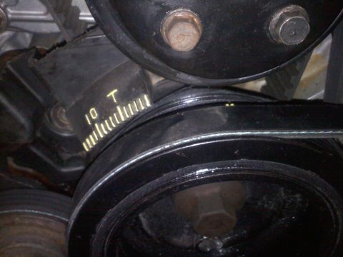 1993 Ford Probe - This image shows a close-up view of an engine's belt tensioner mechanism with visible markings.