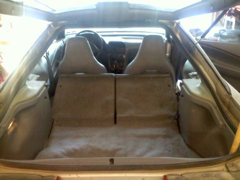 1993 Ford Probe - The interior of a car is shown from the rear, with the cargo area and folded-down rear seats visible.
