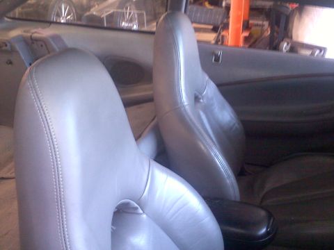1993 Ford Probe - The interior of a vehicle is shown, focusing on the front seats and center console area.
