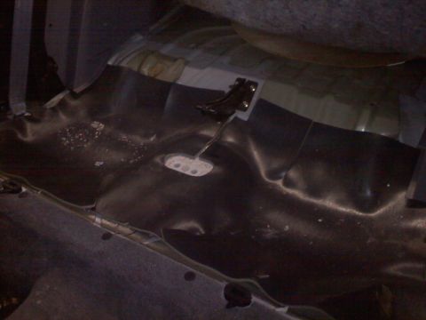 1993 Ford Probe - The interior floor of a car is visible, with pedals and dark carpeting. A watermark indicates the source as SUPERMOTORS.NET.