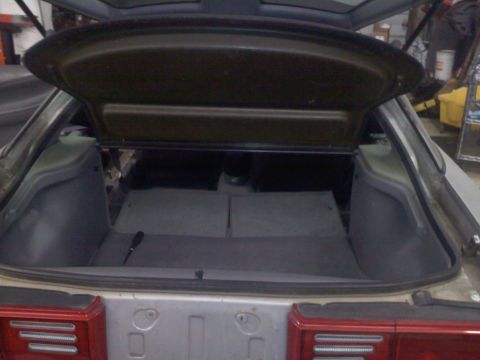 1993 Ford Probe - The trunk of a 1993 Ford Probe GT is open, revealing the interior space and carpeted floor.