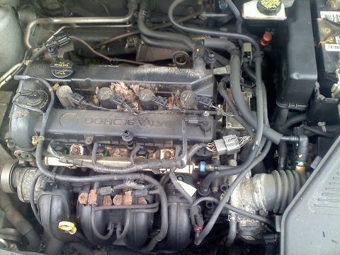 1993 Ford Probe - The engine bay shows a DOHC 16-VALVE engine cover, surrounded by hoses and electrical connectors.