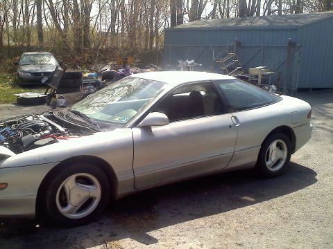 1993 Ford Probe - Silver 1993 Ford Probe GT coupe parked in a yard with the hood open, another car visible in background.