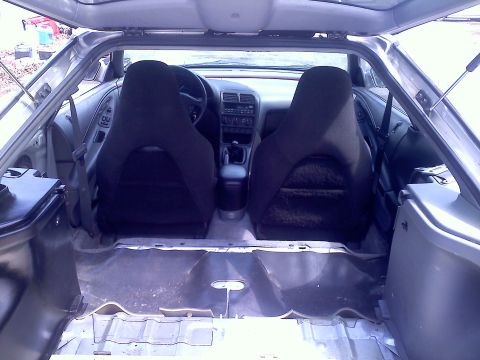 1993 Ford Probe - The interior of a car is shown, with the rear cargo area stripped down to the metal frame.