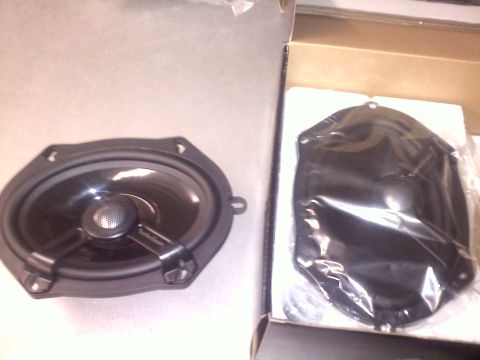 1993 Ford Probe - Car speaker and its mounting bracket shown before installation.