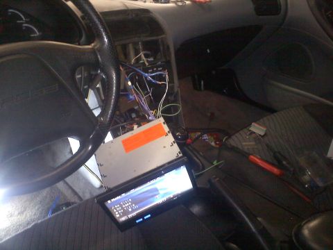 1993 Ford Probe - Dashboard wiring is exposed during the installation of a new car stereo system.